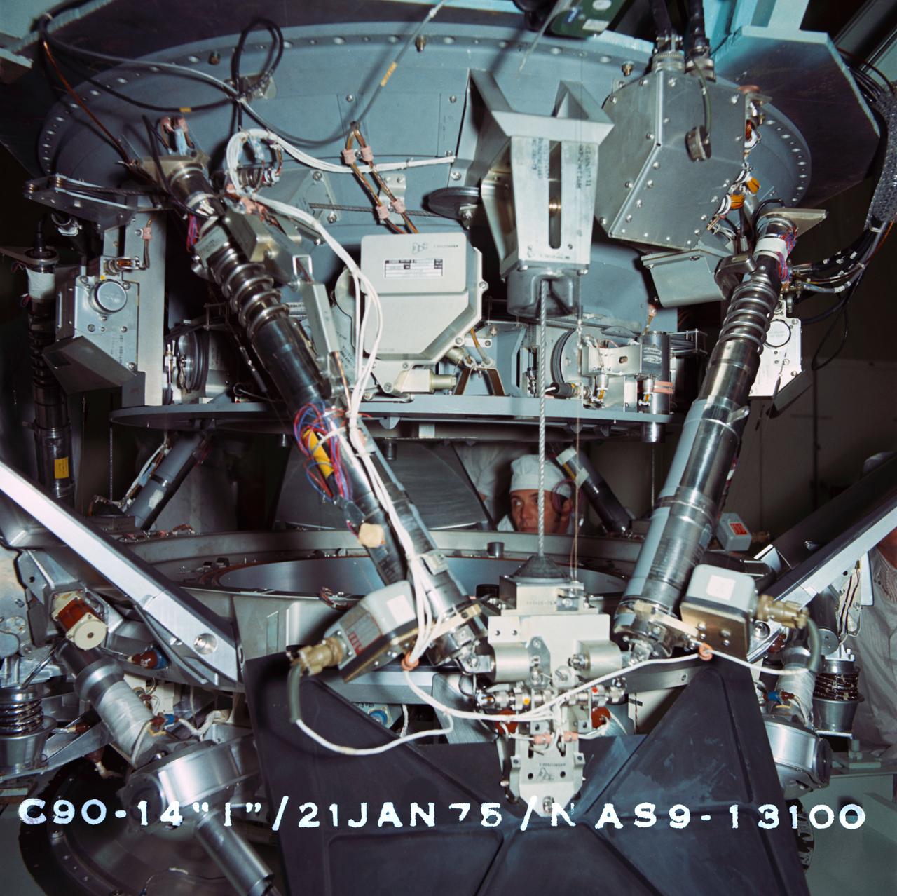 S95-02815 (21 Jan. 1975) --- Soviet junior researcher Y.G. Pobrov observes testing of the Apollo-Soyuz docking system at Rockwell International's plant in Downey, California.  The United States' Docking System 3 (DS-3) here is being positioned onto the USSR's CA-4 system during a Pin and Socket Alignment Test. DS-5 has been designated as the prime flight article for the joint U.S.-USSR Apollo-Soyuz Test Project (ASTP) docking mission in Earth orbit, scheduled for July 1975.