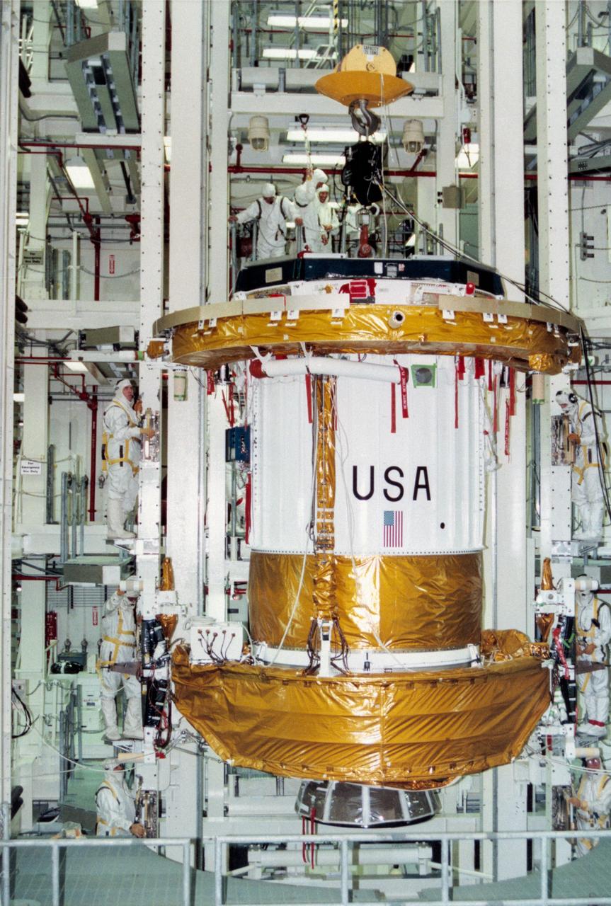 S95-08961  (4 APRIL 1995) --- Workers in the Vertical Processing Facility (VPF) oversee and control the lowering of the Inertial Upper Stage (IUS) booster into a work stand for preflight processing.  The IUS will be attached to the Tracking and Data Relay Satellite (TDRS-G), which will be deployed by the Space Shuttle Discovery on the STS-70 mission.  The IUS is scheduled to be mated to the TDRS satellite later in April.  Liftoff of STS-70 is slated for no earlier than June 8, 1995.