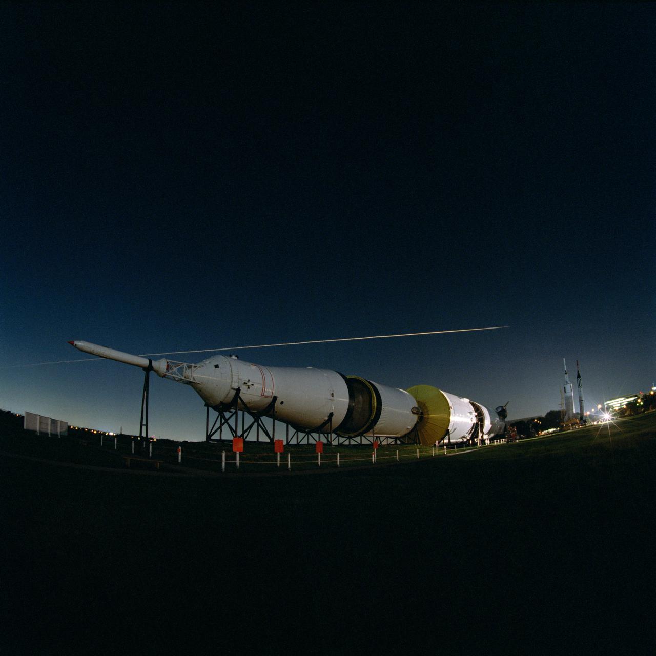 S99-08357 (27 July 1999) --- The fly-over of Space Shuttle Columbia's STS-93 re-entry is seen above the Johnson Space Center's Rocket Park.  The Saturn V is below the streak that was left by Columbia re-entering the atmosphere.  The image was captured with a Hasselblad 503cx medium format camera with a 30mm Hasselblad lens using an 8-second exposure and an aperture setting of f/8.  The film was Kodak PMZ 1000 color negative film.  The photographer was Mark Sowa of the NASA Johnson Space Center's photography group.