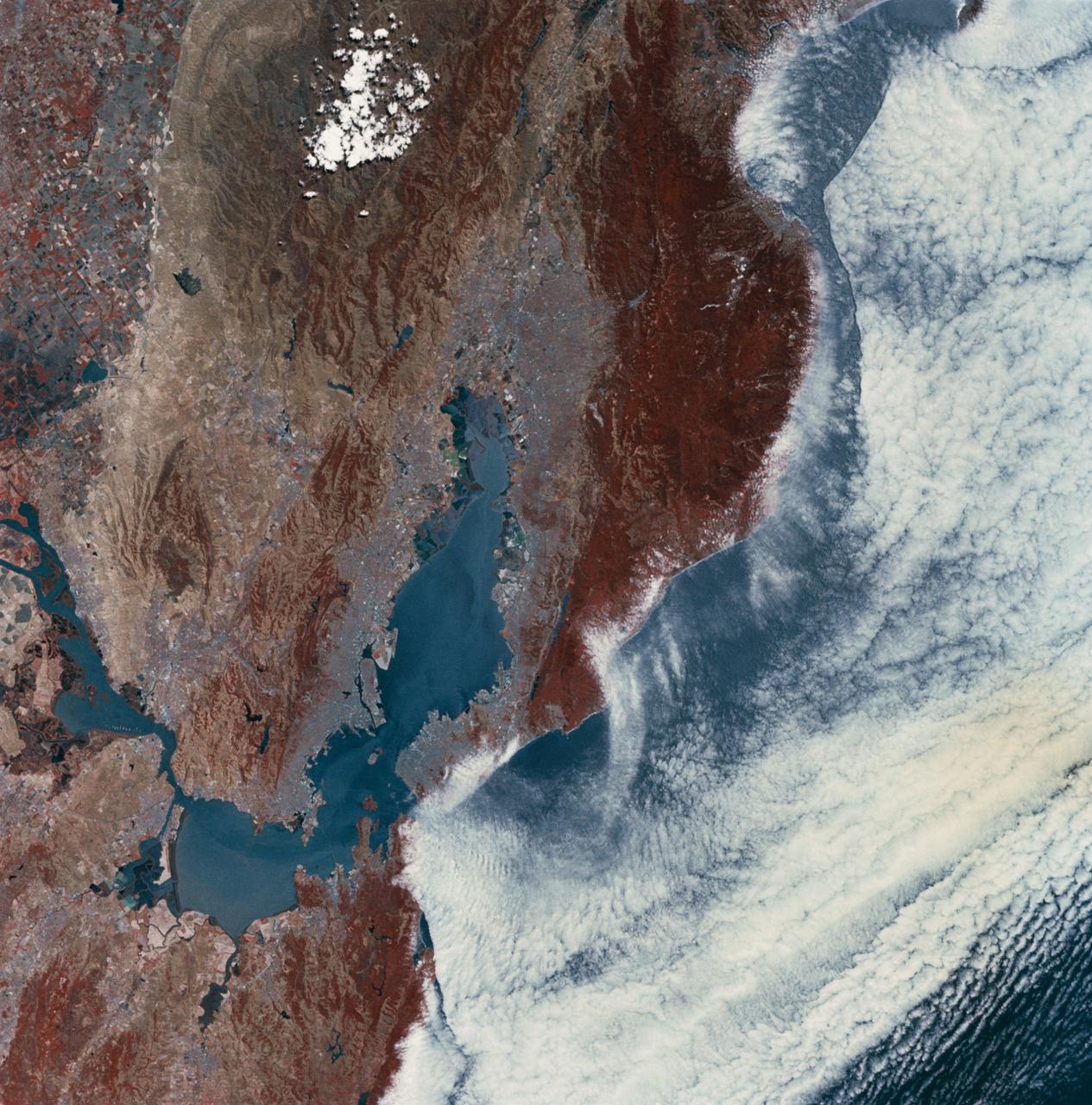 SL2-03-118 (June 1973) --- An infrared photograph of the San Francisco Bay, California area, taken from the Skylab 1/2 space station in Earth orbit. THE PICTURE SHOULD BE HELD WITH THE CLOUDS AND PACIFIC OCEAN ON THE LEFT. This photograph was taken by one of the six lenses of the Itek-furnished S190-A Multispectral Photographic Facility Experiment in the Multiple Docking Adapter of the space station. Type 2443 film was used.  Note the thickly populated and highly developed area around the bay. Among the cities visible in this photograph are San Francisco, Oakland, Berkeley and San Jose.  This view extends eastward to show a portion of the San Joaquin Valley. The S190-A experiment is part of the Skylab Earth Resources Experiment Package (EREP). Photo credit: NASA