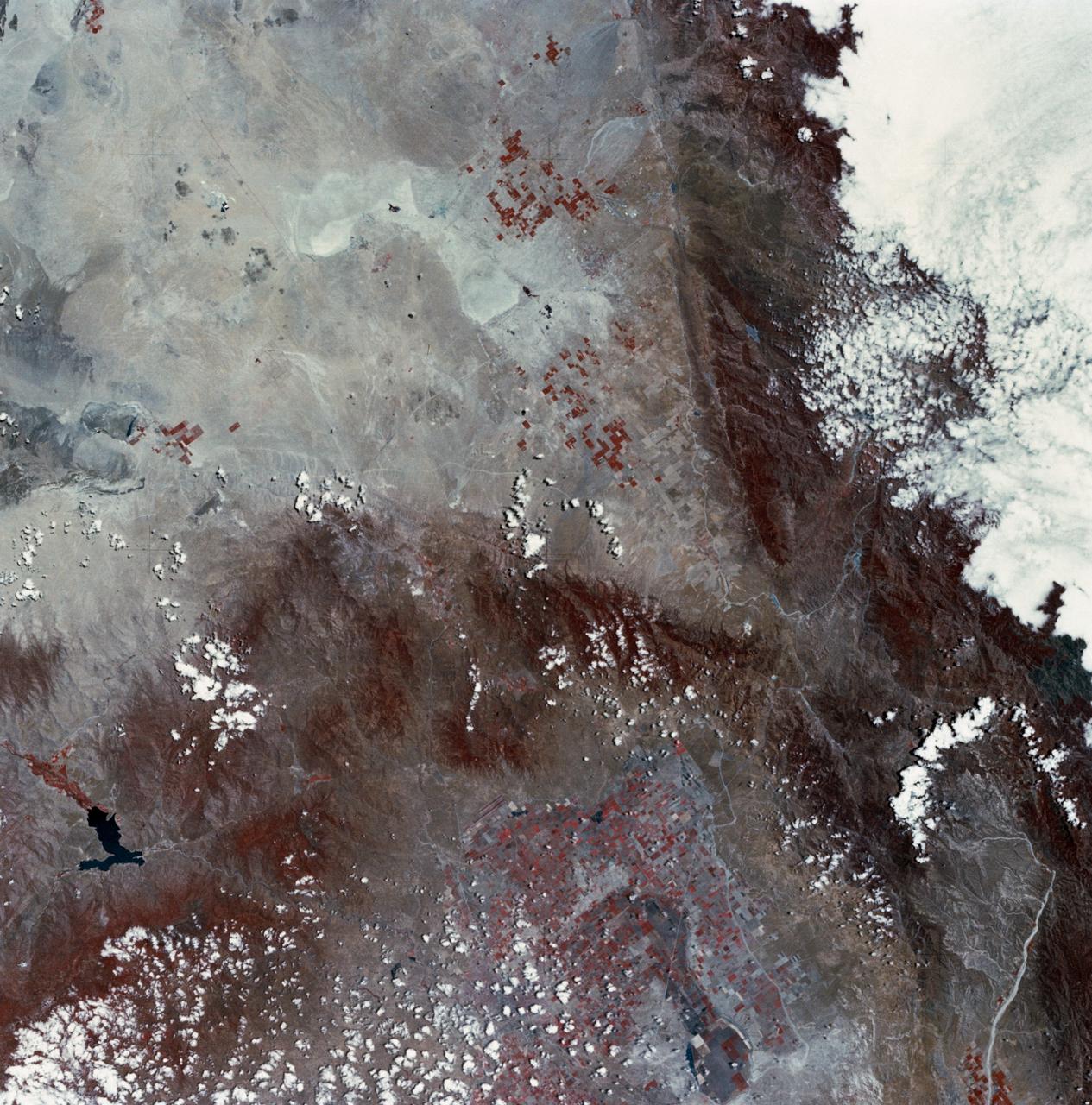 SL2-03-126 (June 1973) --- A color infrared photograph of the Los Angeles County and Kern County area, taken from the Skylab space station in Earth orbit during its first manned Skylab mission. The Mojave Desert occupies the northeast one-fourth of the photograph. Lake Isabella in the Sierra Nevada Mountains is the v-shaped body of water. The San Gabriel Mountains extend across the southern part of the picture. At lower center is the intersection of the San Andreas and Garlock faults. The San Joaquin Valley is in the center at the left edge. (The picture should be held with the heavy cloud cover at lower right corner so that north will be at top.) This picture was exposed by one of the six lenses of the Itek-furnished S190-A Multispectral Photographic Facility experiment in the Multiple Docking Adapter of the Skylab space station. Type 2443 film was used. Photo credit: NASA
