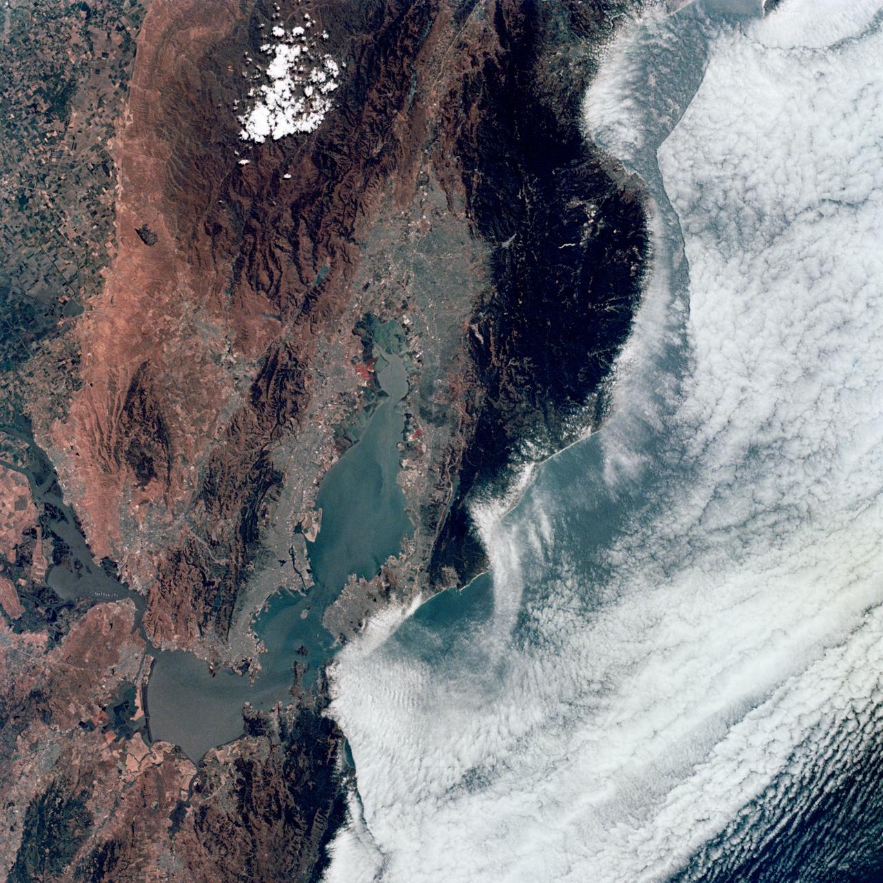 SL2-04-118 (June 1973) --- A color photograph of the San Francisco Bay, California area, taken from the Skylab space station in Earth orbit. (The picture should be held with the clouds and Pacific Ocean on the left.) Note the thickly populated and highly developed area around the bay. Among the cities visible are San Francisco, Oakland, Berkeley and San Jose. This view extends eastward to show a portion of the San Joaquin Valley. This photograph was taken by one of the six lenses of the Itek-furnished S190-A Multispectral Photographic Facility Experiment in the Multiple Docking Adapter of the space station. Type SO-356 film was used. The S190-A experiment is part of the Skylab Earth Resources Experiments Package (EREP). Photo credit: NASA