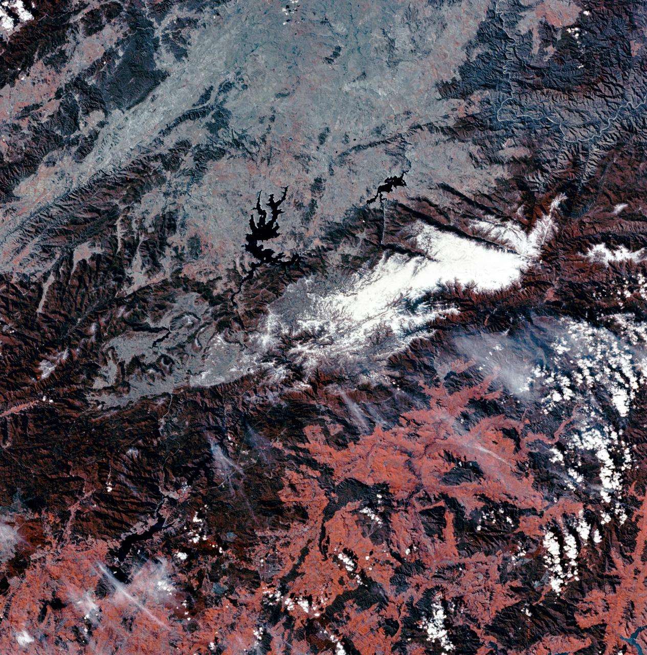 SL3-27-180 (July-September 1973) --- A vertical view of the Snowy Mountains area of Australian Alps in the States of Victoria and New South Wales, Australia, as photographed from Earth orbit by one of the six lenses of the Itek-furnished S190-A Multispectral Photographic Facility Experiment aboard the Skylab space station. This picture was taken with type 2443 infrared color film. The lake near the center of the picture is the Eucumbene Reservoir. This area is located immediately south-southwest of the capital city of Canberra. Federal agencies participating with NASA on the EREP project are the Departments of Agriculture, Commerce, Interior, the Environmental Protection Agency and the Corps of Engineers. All EREP photography is available to the public through the Department of Interior?s Earth Resources Observations Systems Data Center, Sioux Falls, South Dakota, 57198. Photo credit: NASA