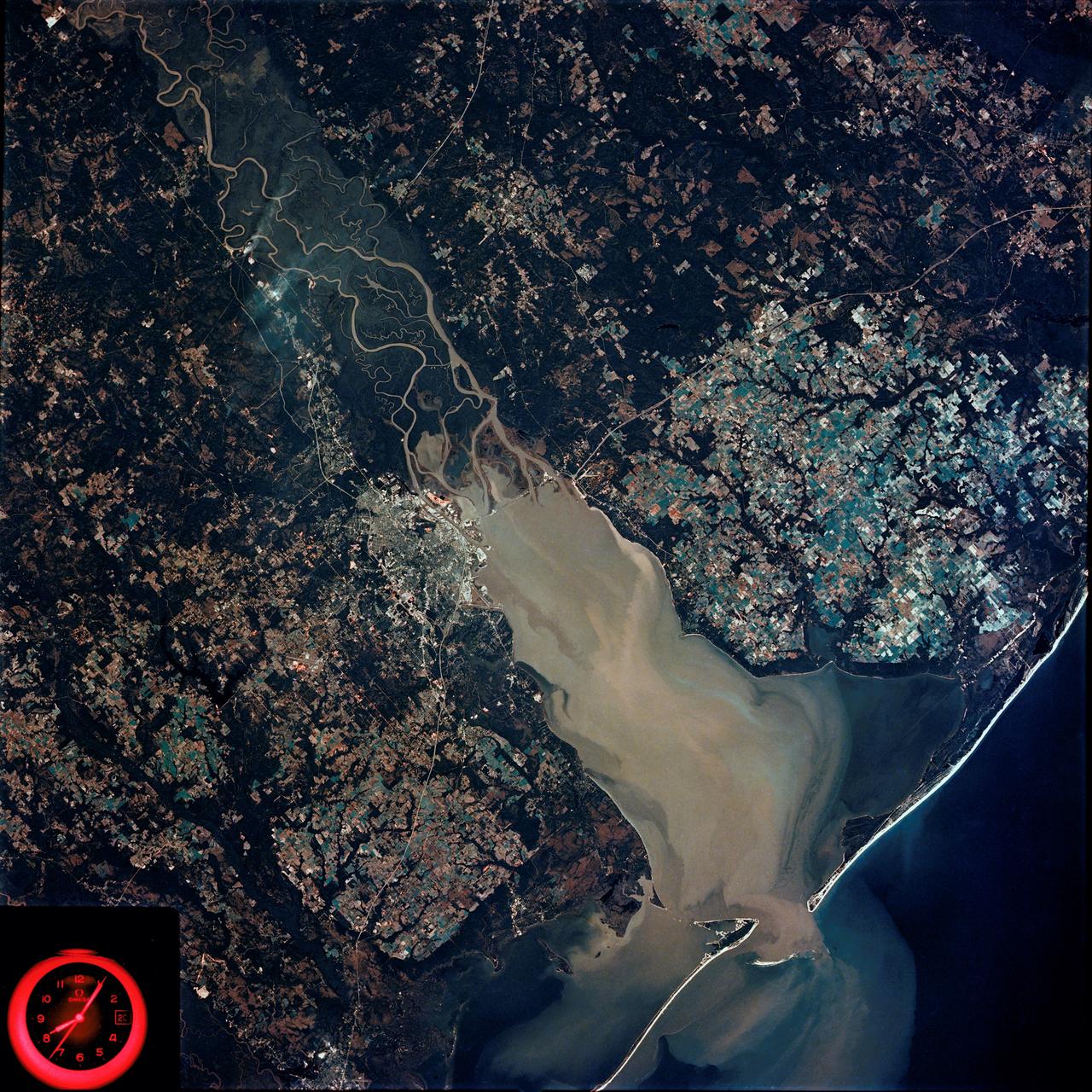 SL4-92-300 (February 1974) --- A near vertical view of the Mobile Bay, Alabama area is seen in this Skylab 4 Earth Resources Experiments Package S190-B (five-inch earth terrain camera) photograph taken from the Skylab space station in Earth orbit. North of Mobile the Tombigbee and Alabama Rivers join to form the Mobile River. Detailed configuration of the individual stream channels and boundaries can be defined as the Mobile River flows into Mobile Bay, and thence into the Gulf of Mexico. The Mobile River Valley with its numerous stream channels is a distinct light shade in contrast to the dark green shade of the adjacent areas. The red coloration of Mobile Bay reflects the sediment load carried into the Bay by the rivers. Variations in red color indicate sediment load and the current paths within Mobile Bay. The waterly movement of the along shore currents at the mouth of Mobile Bay is shown by the contrasting light blue of the sediment-laden current and the blue of the Gulf predominately. Agricultural areas east and west of Mobile Bay are characterized by a rectangular pattern in green to white shades. Color variations may reflect the type and growth cycle of crops. Agricultural areas (light gray-greens) are also clearly visible in other parts of the photograph. Interstate 10 extends from near Pascagoula, Mississippi eastward through Mobile to the outskirts of Pensacola, Florida. Analysis of the EREP photographic data will be undertaken by the U.S. Corps of Engineers to determine bay dynamic processes. Federal agencies participating with NASA on the EREP project are the Departments of Agriculture, Commerce, Interior, the Environmental Protection Agency and the Corps of Engineers. All EREP photography is available to the public through the Department of Interior's Earth Resources Observations Systems Data Center, Sioux Falls, South Dakota. 57198 Photo credit: NASA