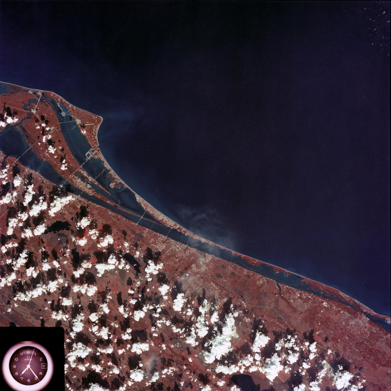 SL4-93-167 (February 1974) --- A vertical view of the Kennedy Space Center and the Florida Atlantic coast area is seen in this Skylab 4 Earth Resources Experiments Package S190-B (five-inch earth terrain camera) infrared photography taken from the Skylab space station in Earth orbit. This photograph shows the major land-ocean features of the Florida coast near Vero Beach northward to Cape Canaveral and the KSC complex. The launch pads for the Skylab missions are clearly visible. Identification of living vegetation is possible through the use of the color infrared film. Various shades of red portray differences in the vegetation such as shown in the patterns in the agricultural area near Vero Beach. In the Kennedy Space Center, the nearly continuous and uniform red color shows that most of the land areas are heavily vegetated. The white coastal beach areas are strongly contrasted to the red land and the blue Atlantic Ocean. Old dunal areas in KSC are visible on Merritt Island which is separated from the Launch areas by the Banana River and the mainland by the Indian River. Federal and state highways and numerous causeways over the rivers are easily identified. The Florida mainland is partly shadowed by small white clouds which cast a pronounced shadow to the east of each cloud indicated the Sun is west of solar noon. Federal agencies participating with NASA on the EREP project are the Departments of Agriculture, Commerce, Interior, the Environmental Protection Agency and the Core of Engineers. All EREP photography is available to the public through the Department of Interior's Earth Resources Observations Systems Data Center, Sioux Falls, South Dakota, 57198. Photo credit: NASA