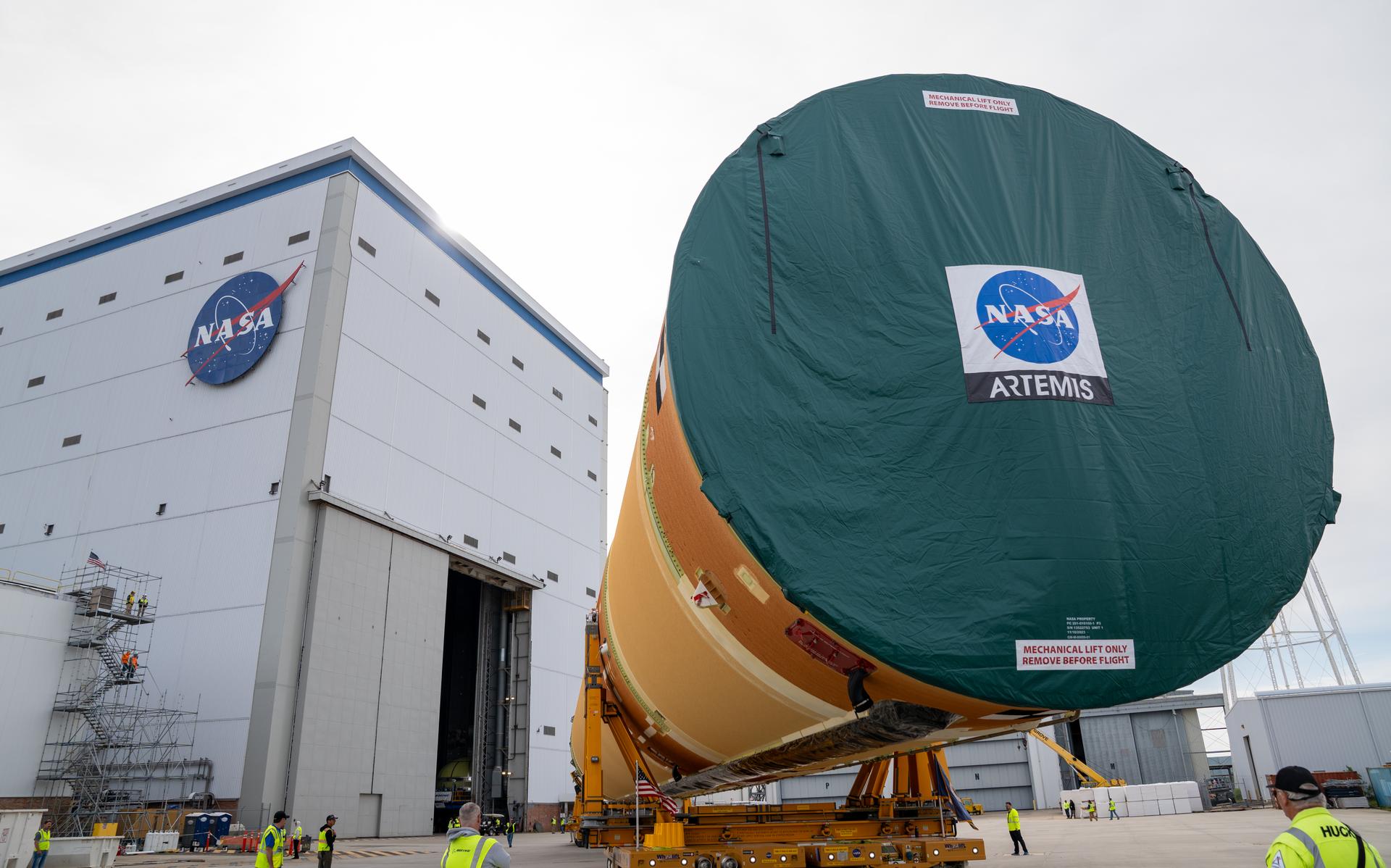 NASA moved the core stage, or the largest section, of the SLS (Space Launch System) rocket that will launch the crewed Artemis III mission in 2027 from the agency’s Michoud Assembly Facility to the agency’s Pegasus barge in New Orleans on April 20. The barge will ferry the top four-fifths – the section containing the liquid hydrogen tank, liquid oxygen tank, intertank, and forward skirt – of the SLS core stage to NASA’s Kennedy Space Center in Florida to complete outfitting and vertical integration.  Teams with NASA and Boeing, the SLS core stage lead contractor, used specialized transporters to guide the top four-fifths from the NASA rocket factory to Pegasus. Prior to the move, technicians added an engine section transportation simulator to the rocket stage for shipment to the Space Coast.  Next year’s Artemis III mission will launch astronauts to Earth’s orbit aboard the Orion spacecraft on top of SLS to test rendezvous and docking capabilities between Orion and commercial spacecraft needed to land Artemis IV astronauts on the Moon in 2028. NASA’s SLS is the only rocket capable of sending Orion, astronauts, and supplies to the Moon in a single launch.    Photo Credit: (NASA/Brandon Hancock)