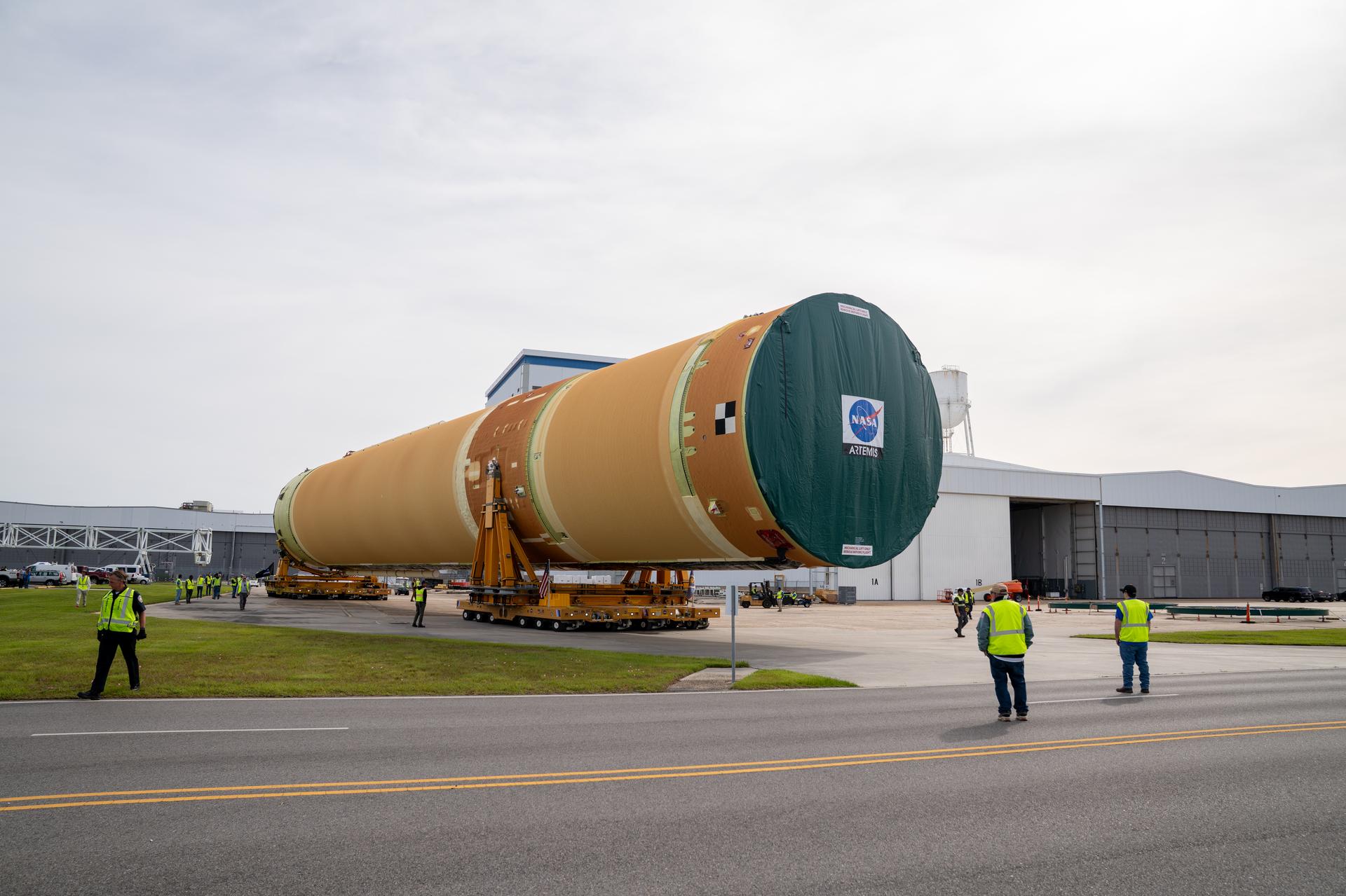 NASA moved the core stage, or the largest section, of the SLS (Space Launch System) rocket that will launch the crewed Artemis III mission in 2027 from the agency’s Michoud Assembly Facility to the agency’s Pegasus barge in New Orleans on April 20. The barge will ferry the top four-fifths – the section containing the liquid hydrogen tank, liquid oxygen tank, intertank, and forward skirt – of the SLS core stage to NASA’s Kennedy Space Center in Florida to complete outfitting and vertical integration.  Teams with NASA and Boeing, the SLS core stage lead contractor, used specialized transporters to guide the top four-fifths from the NASA rocket factory to Pegasus. Prior to the move, technicians added an engine section transportation simulator to the rocket stage for shipment to the Space Coast.  Next year’s Artemis III mission will launch astronauts to Earth’s orbit aboard the Orion spacecraft on top of SLS to test rendezvous and docking capabilities between Orion and commercial spacecraft needed to land Artemis IV astronauts on the Moon in 2028. NASA’s SLS is the only rocket capable of sending Orion, astronauts, and supplies to the Moon in a single launch.   Photo Credit: (NASA/Brandon Hancock)