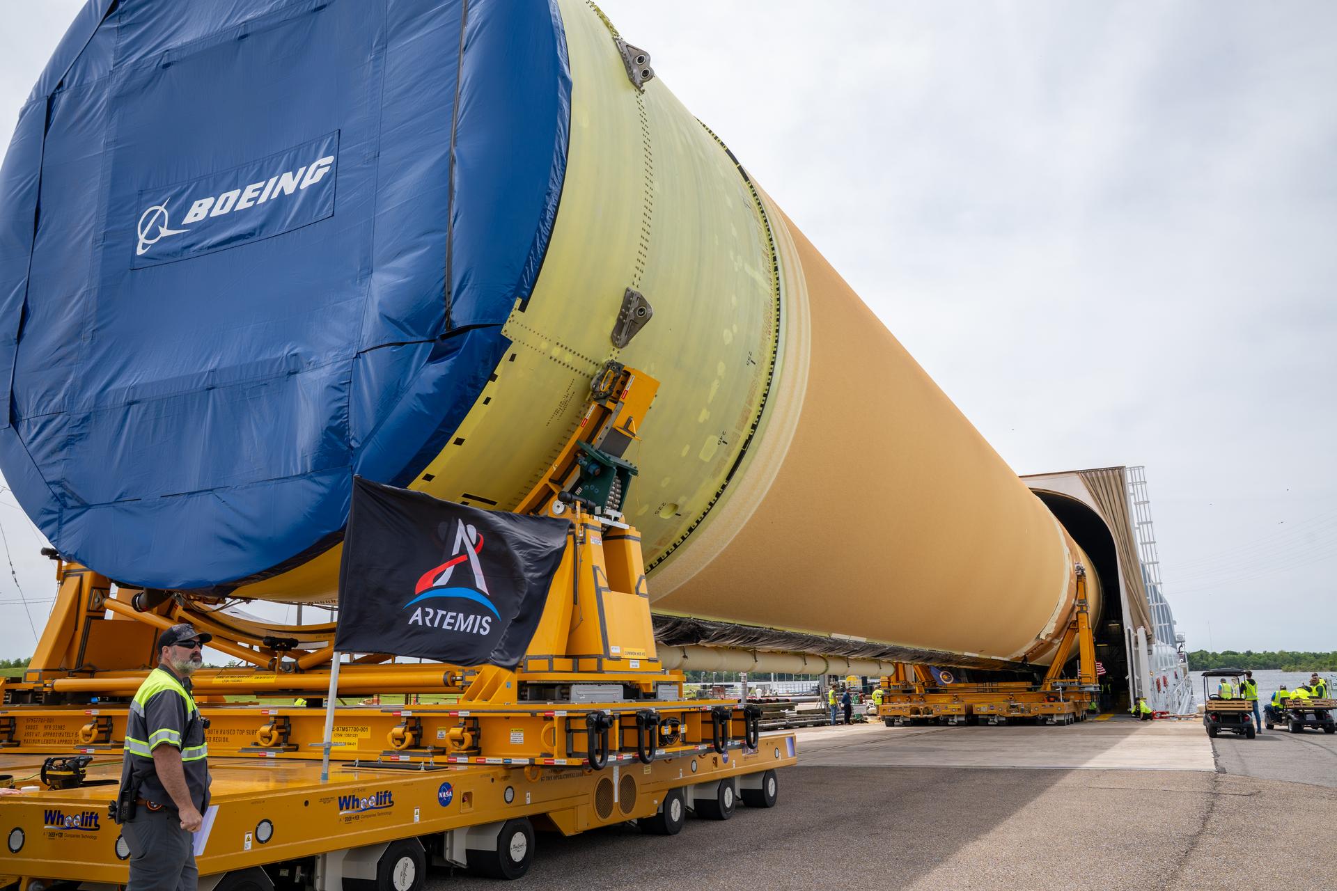 NASA moved the core stage, or the largest section, of the SLS (Space Launch System) rocket that will launch the crewed Artemis III mission in 2027 from the agency’s Michoud Assembly Facility to the agency’s Pegasus barge in New Orleans on April 20. The barge will ferry the top four-fifths – the section containing the liquid hydrogen tank, liquid oxygen tank, intertank, and forward skirt – of the SLS core stage to NASA’s Kennedy Space Center in Florida to complete outfitting and vertical integration.  Teams with NASA and Boeing, the SLS core stage lead contractor, used specialized transporters to guide the top four-fifths from the NASA rocket factory to Pegasus. Prior to the move, technicians added an engine section transportation simulator to the rocket stage for shipment to the Space Coast.  Next year’s Artemis III mission will launch astronauts to Earth’s orbit aboard the Orion spacecraft on top of SLS to test rendezvous and docking capabilities between Orion and commercial spacecraft needed to land Artemis IV astronauts on the Moon in 2028. NASA’s SLS is the only rocket capable of sending Orion, astronauts, and supplies to the Moon in a single launch. Photo Credit: (NASA/Brandon Hancock)