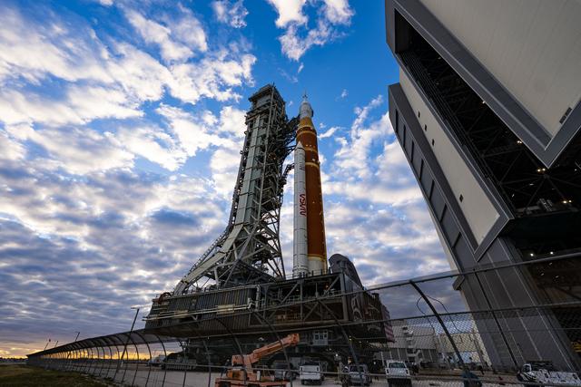 This image shows NASA’s SLS (Space Launch System) and Orion spacecraft rollin...