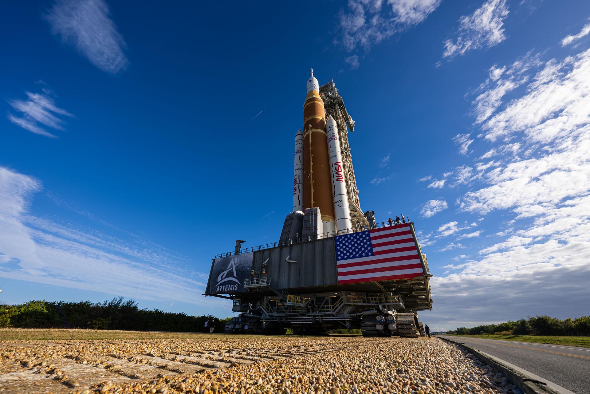 This image shows NASA’s SLS (Space Launch System) and Orion spacecraft rolling out of the Vehicle Assembly Building at NASA’s Kennedy Space Center. NASA's massive Crawler-Transporter, upgraded for the Artemis program, carries the powerful SLS rocket and Orion spacecraft on the Mobile Launcher from the Vehicle Assembly Building to Launch Pad 39B at Kennedy Space Center in preparation for the Artemis II mission.