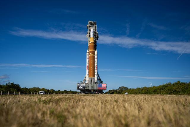 This image shows NASA’s SLS (Space Launch System) and Orion spacecraft rollin...