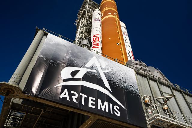 This image shows NASA’s SLS (Space Launch System) and Orion spacecraft rollin...