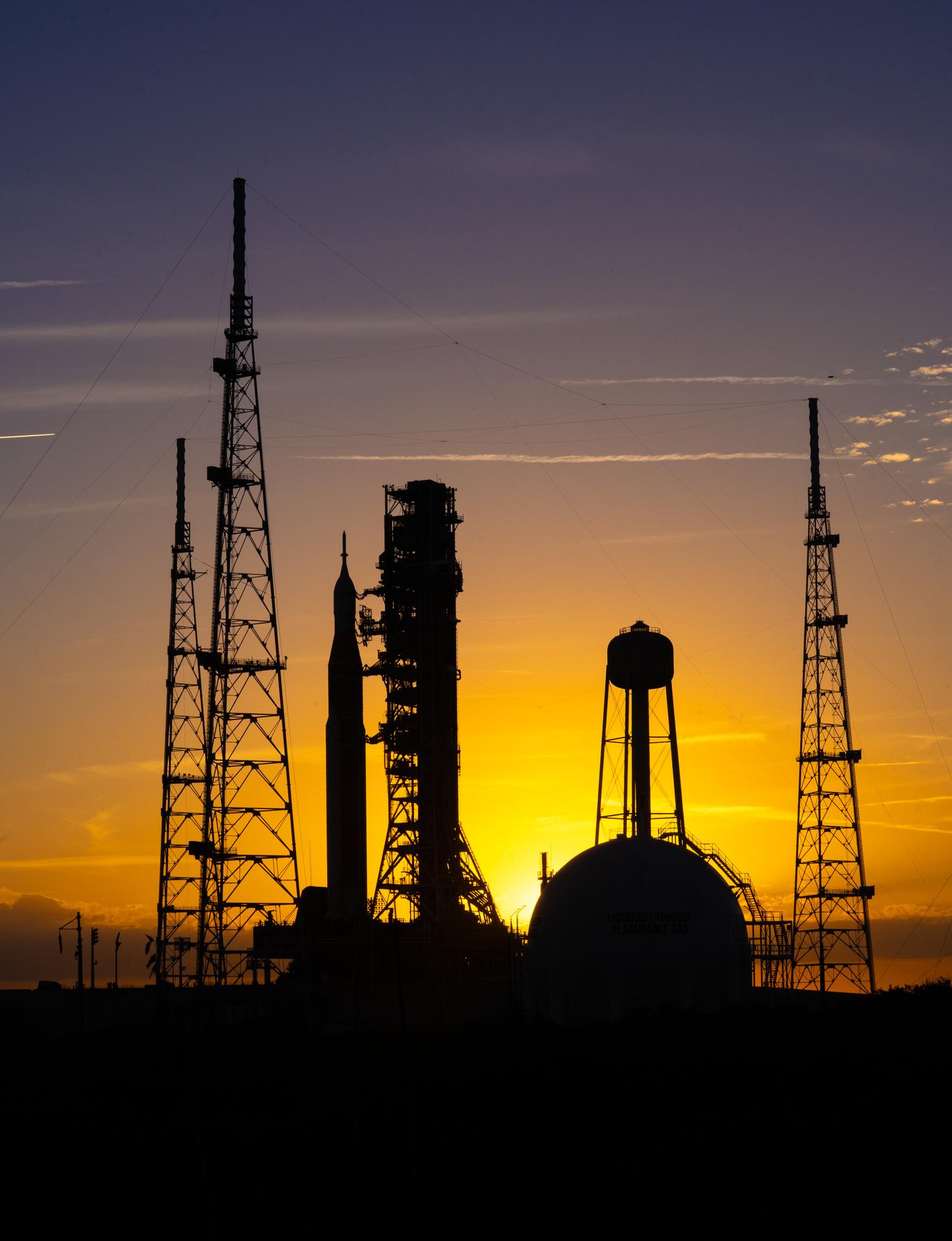 This image shows NASA’s SLS (Space Launch System) and Orion spacecraft rolling out of the Vehicle Assembly Building at NASA’s Kennedy Space Center. NASA's massive Crawler-Transporter, upgraded for the Artemis program, carries the powerful SLS rocket and Orion spacecraft on the Mobile Launcher from the Vehicle Assembly Building to Launch Pad 39B at Kennedy Space Center in preparation for the Artemis II mission.