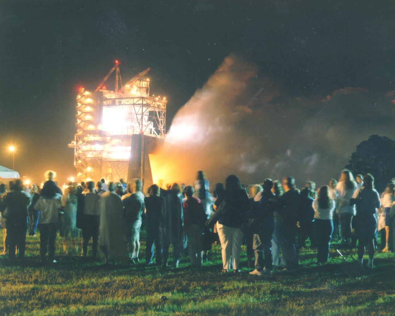 Thousands of people watch the first-ever evening public engine test of a Space Shuttle Main Engine at NASA's John C. Stennis Space Center. The spectacular test marked Stennis Space Center's 20th anniversary celebration of the first Space Shuttle mission.