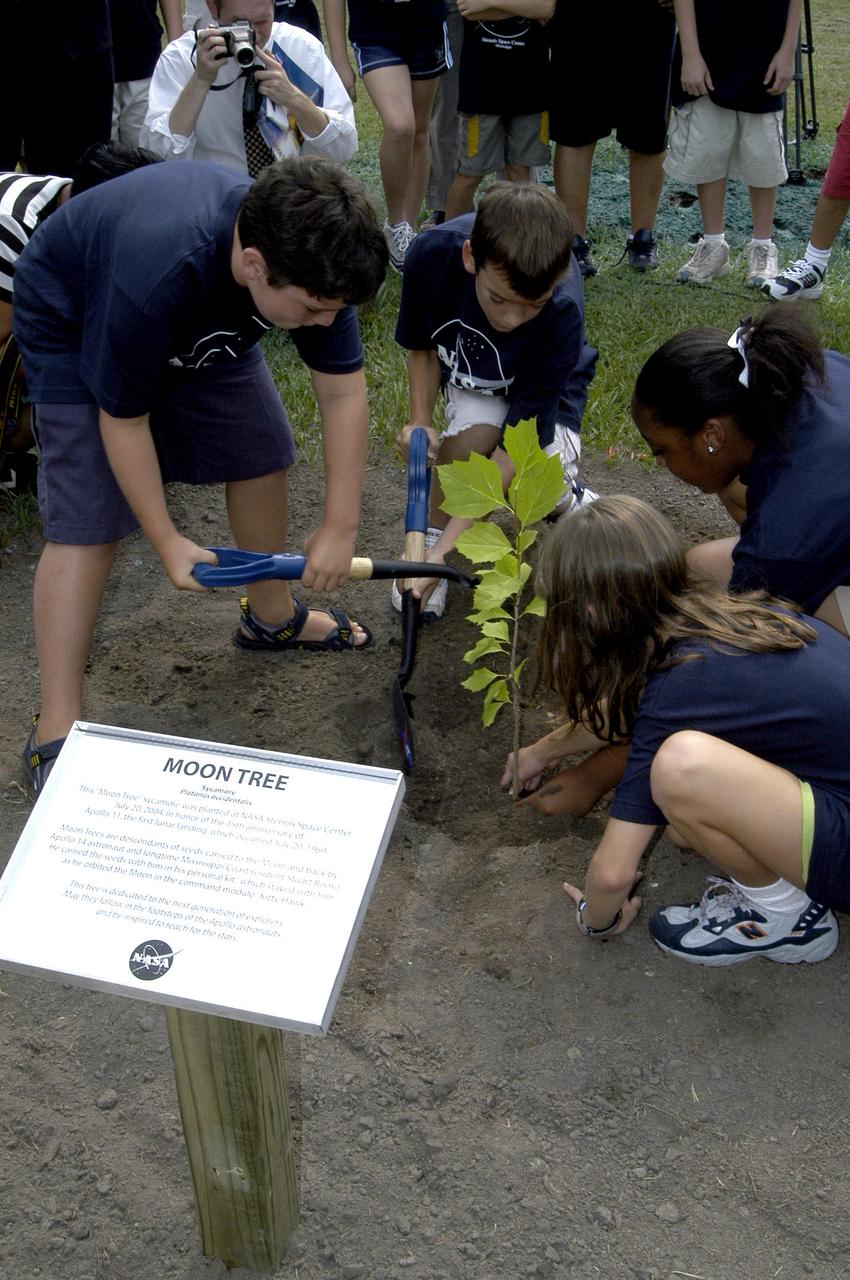 An image from July 20, 2004, shows Astro Camp participants planting a sycamore Moon tree at NASA’s Stennis Space Center near Bay St. Louis, Mississippi. The tree honors the 35th anniversary of Apollo 11 and the first lunar landing on July 20, 1969.