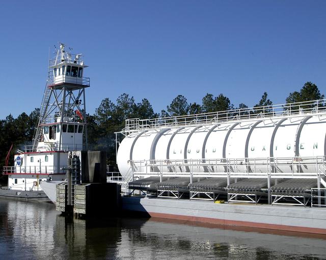 NASA image: Tug Clermont II moves a LOX-filled barge on the canal