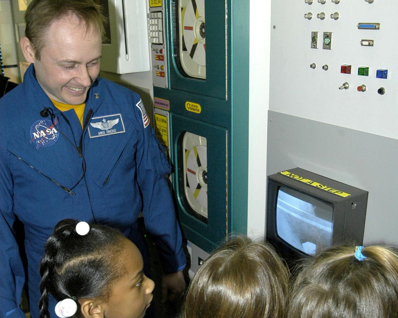 NASA Astronaut Mike Fincke talks with students about his six-month stay aboard the International Space Station during a visit to StenniSphere, the visitor center at NASA's Stennis Space Center.