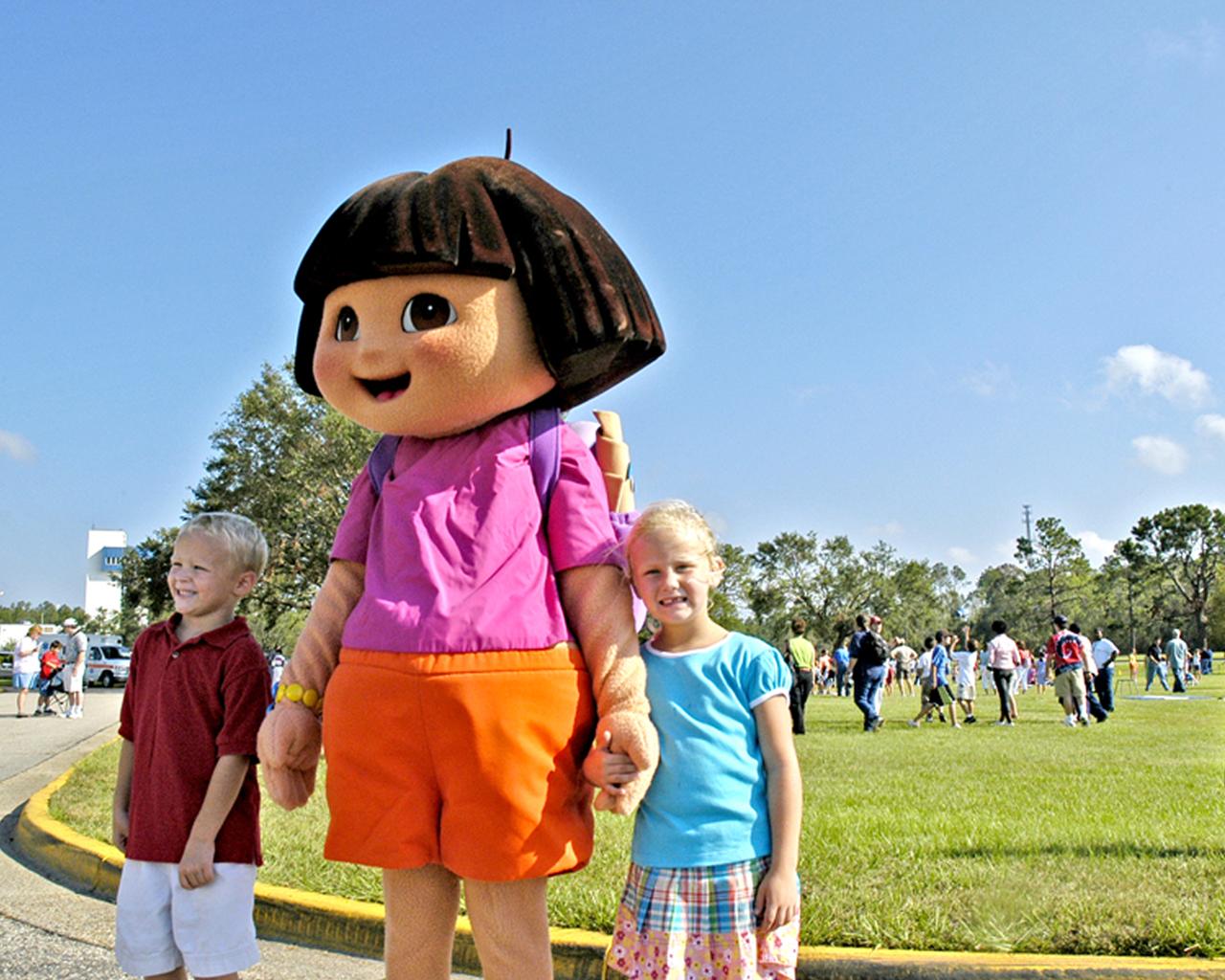 From left, Cobie Smith, 5, and Tatume Smith, also 5, have their picture taken with 'Dora the Explorer.' The children were participants in Nickelodeon's Worldwide Day of Play celebration at Stennis Space Center (SSC) on Oct. 1. The Worldwide Day of Play is sponsored annually by Nickelodeon television network to encourage children to be physically active. Approximately 150 children participated in the event at SSC.