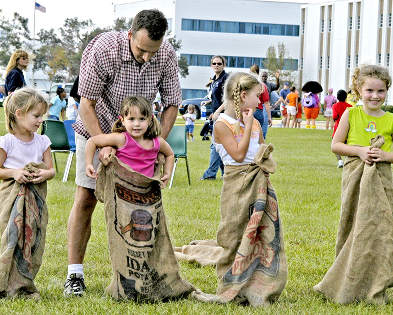 From left, Mallory Doody, 5, Natalie Cambre, 3, Madison Doody, 7, and Anna Cambre, 6, get ready to compete in a sack race. The children were participants in Nickelodeon's Worldwide Day of Play celebration at Stennis Space Center (SSC) on Oct. 1. The Worldwide Day of Play is sponsored annually by Nickelodeon television network to encourage children to be physically active.
