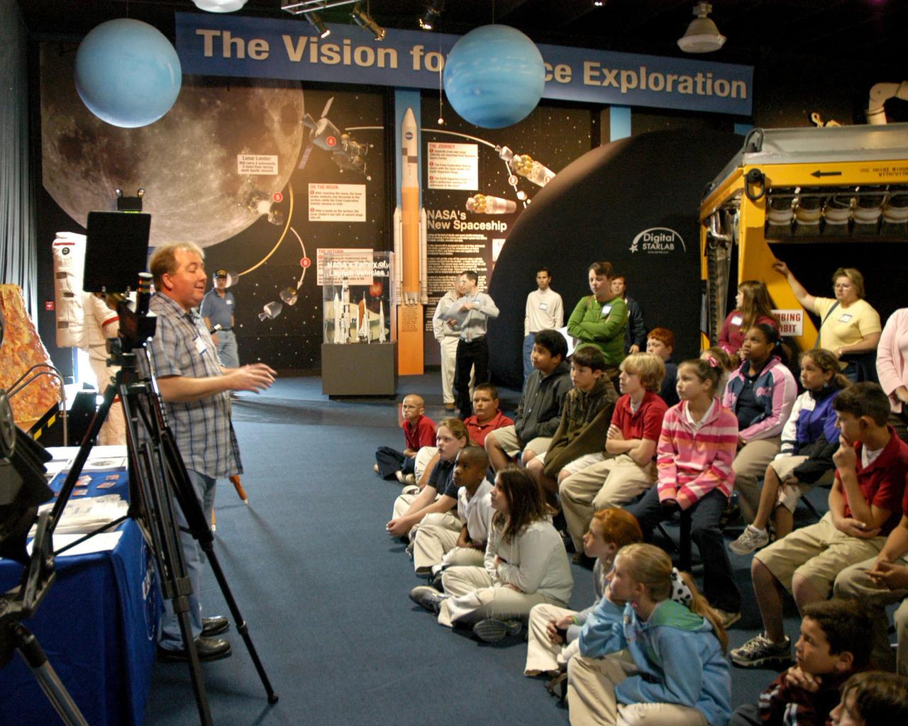 Michael Sandras, a member of the Pontchartrain Astronomical Society, explains his solar telescope to students of Second Street in Bay St. Louis, Hancock County and Nicholson elementary schools in StenniSphere's Millennium Hall on April 10. The students participated in several hands-on activities at Stennis Space Center's Sun-Earth Day celebration.