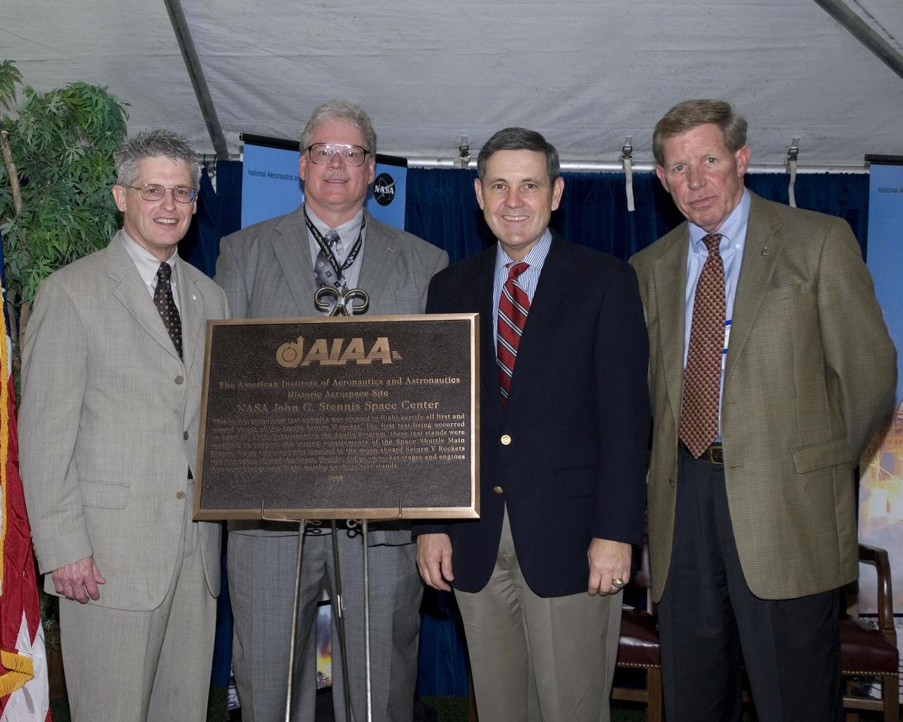Picured (left to right) American Institute of Aeronautics and Astronautics (AIAA) representative David Throckmorton presents a plaque designating NASA's John C. Stennis Space Center as a historical aerospace site during an April 10 ceremony. Joining Throckmorton for the presentation were AIAA Greater New Orleans Chapter Chair Mark Hughes, Stennis Space Center Director Bob Cabana and Pratt & Whitney Rocketdyne Vice President John Plowden.