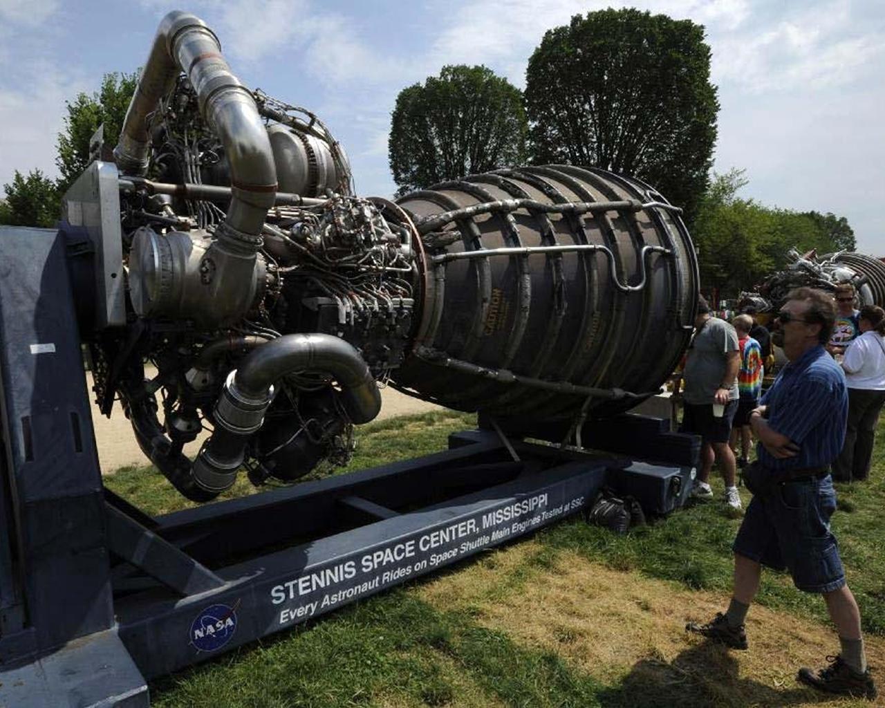 A visitor to the Smithsonian Folklife Festival in Washington, D.C., examines a space shuttle main engine display provided by Stennis Space Center. Since 1975, Stennis has been responsible for testing every engine used in NASA's Space Shuttle Program.