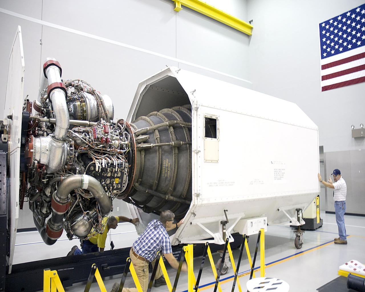 Workers at Stennis Space Center examine space shuttle main engine 2061 upon its arrival Oct. 1. The engine was to be the last shuttle flight engine to be scheduled for testing at Stennis.