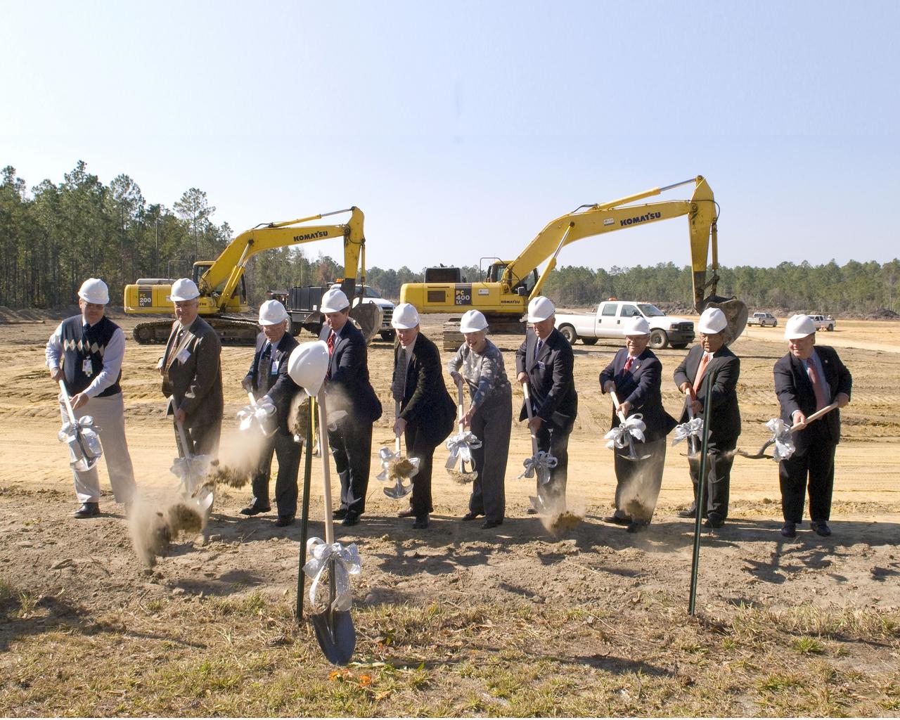 Community leaders from Mississippi and Louisiana break ground for the new INFINITY at NASA Stennis Space Center facility during a Nov. 20 ceremony. Groundbreaking participants included (l to r): Gottfried Construction representative John Smith, Mississippi Highway Commissioner Wayne Brown, INFINITY board member and Apollo 13 astronaut Fred Haise, Stennis Director Gene Goldman, Studio South representative David Hardy, Leo Seal Jr. family representative Virginia Wagner, Hancock Bank President George Schloegel, Mississippi Rep. J.P. Compretta, Mississippi Band of Choctaw Indians representative Charlie Benn and Louisiana Sen. A.G. Crowe.