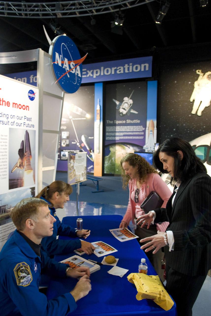 Commander Christopher Ferguson (left) and Mission Specialist Heidemarie Stefanyshyn-Piper, both members of the STS-126 shuttle mission, sign autographs for Stennis employees Jan. 13 during a visit to StenniSphere.