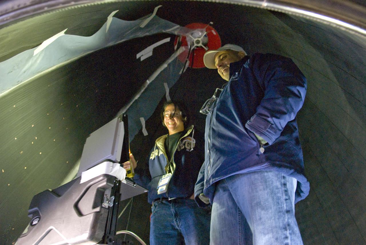 Joel Perez (left) and Jay Labat, both of Pratt & Whitney Rocketdyne, are in close quarters as they check for leaks inside the nozzle of a space shuttle main engine mounted on the A-2 Test Stand.