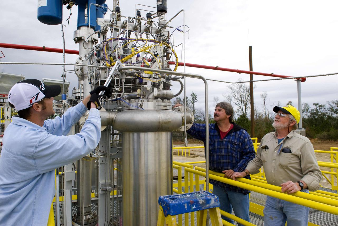 Kanaly Slade, Pat Guidry and Danny Tarter, all of Jacobs NTOG, make adjustments to the chemical steam generator installed on the E-2 Test Stand.