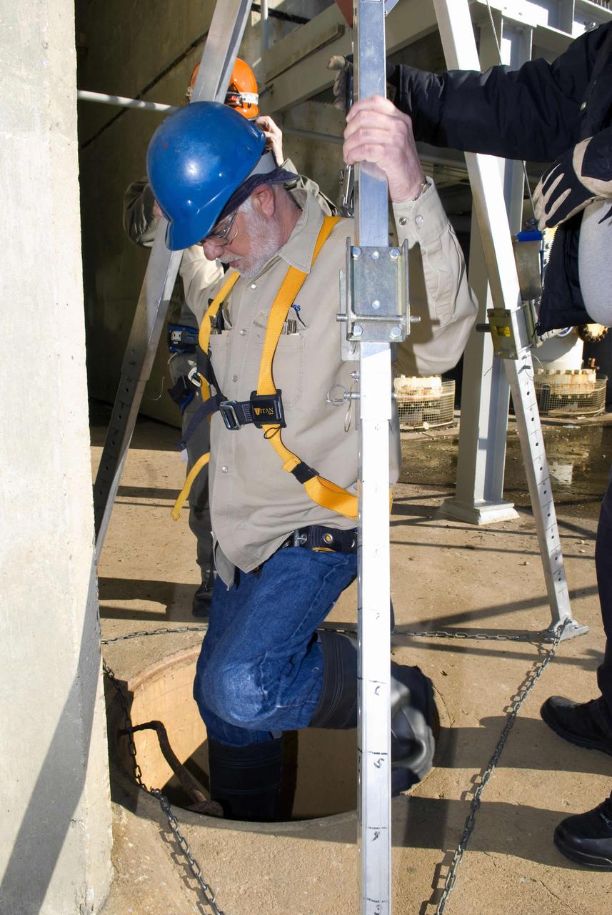 Robert Hayward of Jacobs FOSC descends beneath the B-1 Test Stand to perform maintenance.