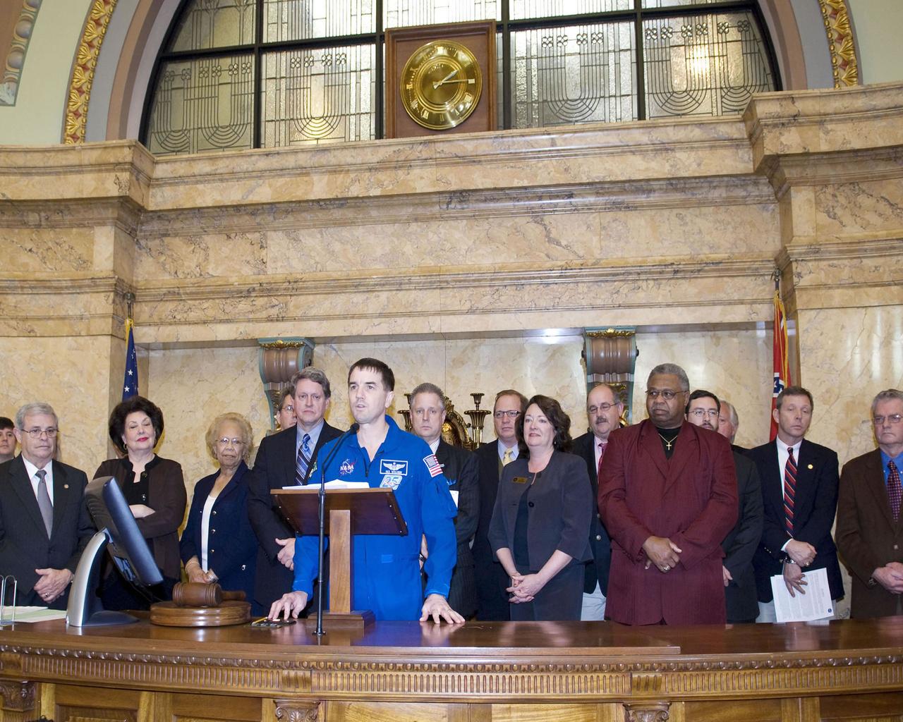 Stennis Space Center leaders and guests visit with Mississippi Senate members in chambers during NASA Day at the Capitol events in Jackson on Feb. 19. Standing at the Senate podium (rear) is Mississippi Lt. Gov. Phil Bryant. Standing at the lectern below are (l to r): Sen. David Baria, D-Bay St. Louis; Partners for Stennis Chair Clay Wagner; NASA Shared Services Center Director Rick Arbuthnot; astronaut Rex Walheim; Stennis Space Center Director Gene Goldman; President Pro Tempore Billy Hewes, R-Gulfport; Sen. Ezell Lee, D-Picayune; and Sen. Tommy Gollott, R-Biloxi.