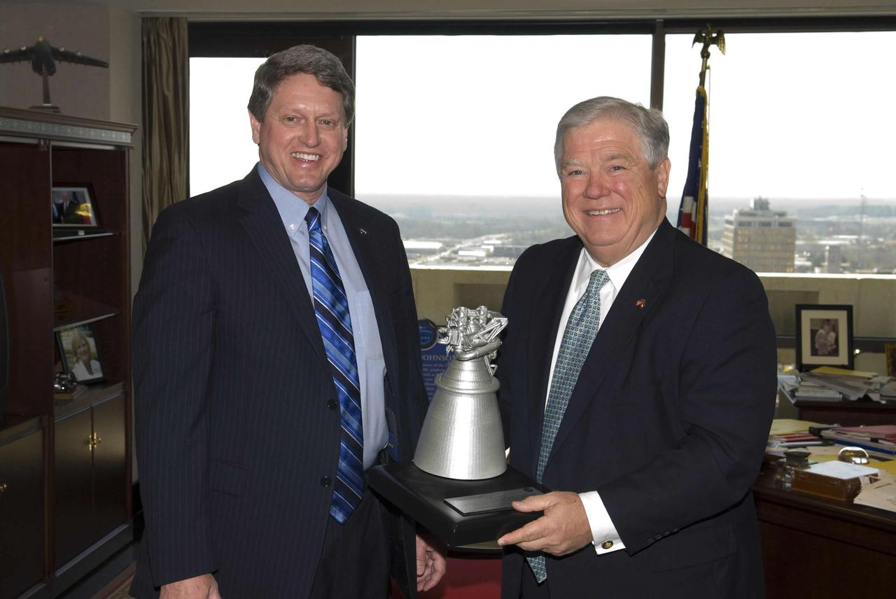Stennis Space Center Director Gene Goldman visits with Mississippi Gov. Haley Barbour during NASA Day at the Capitol activities on Feb. 19. During the visit, Goldman presented the governor with a model of the J-2X rocket engine currently in development. Stennis engineers did early component testing for the new engine.
