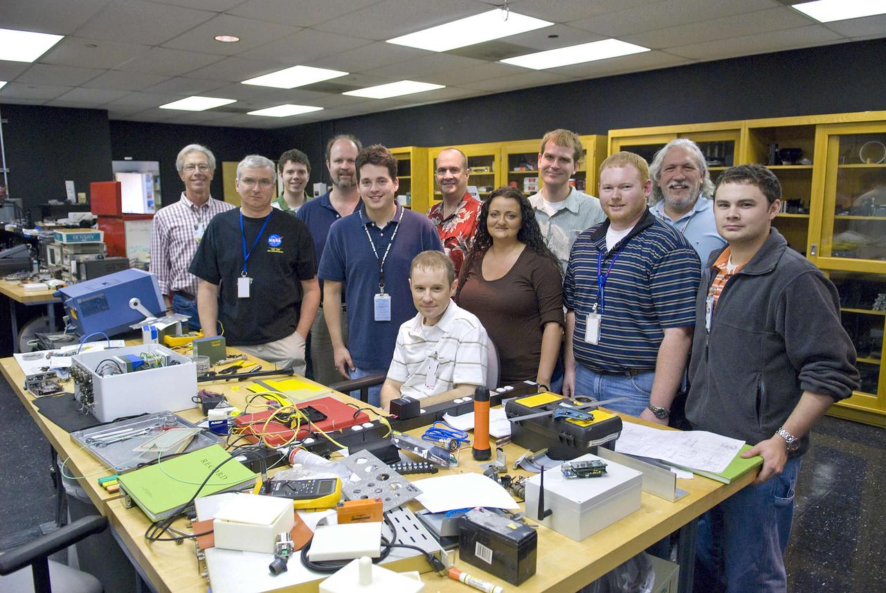 Engineers working on the smart and intelligent sensor payload project include (l to r): Ed Conley (NASA), Mark Mitchell (Jacobs Technology), Luke Richards (NASA), Robert Drackett (Jacobs Technology), Mark Turowski (Jacobs Technology) , Richard Franzl (seated, Jacobs Technology), Greg McVay (Jacobs Technology), Brianne Guillot (Jacobs Technology), Jon Morris (Jacobs Technology), Stephen Rawls (NASA), John Schmalzel (NASA) and Andrew Bracey (NASA).