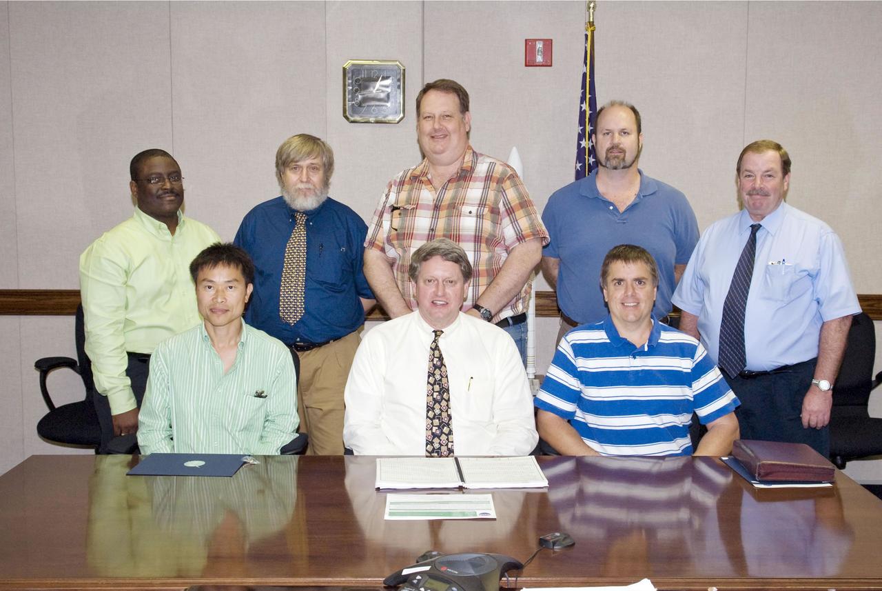 The NASA Engineering & Safety Center recently presented its Group Achievement Award to a Stennis team in recognition of technical excellence in evaluating the operational anomalies and reliability improvements associated with the space shuttle engine cut-off system. Stennis employees receiving the award were: (standing, l to r) Freddie Douglas (NASA), George Drouant (Jacobs Technology Inc.), Fred Abell (Jacobs), Robert Drackett (Jacobs) and Mike Smiles (NASA); (seated, l to r): Binh Nguyen (Jacobs), Stennis Director Gene Goldman and Joseph Lacker (NASA). Phillip Hebert of NASA is not pictured.