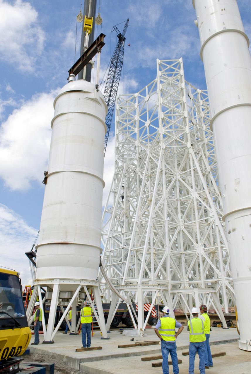 A liquid oxygen (LOX) tank is lifted into place at the A-3 Test Stand being built at NASA's John C. Stennis Space Center. Fourteen LOX, isopropyl alcohol (IPA) and water tanks are being installed to support the chemical steam generators to be used on the A-3 Test Stand. The IPA and LOX tanks will provide fuel for the generators. The water will allow the generators to produce steam that will be used to reduce pressure inside the stand's test cell diffuser, enabling operators to simulate altitudes up to 100,000 feet. In that way, operators can perform the tests needed on rocket engines being built to carry humans back to the moon and possibly beyond. The A-3 Test Stand is set for completion and activation in 2011.