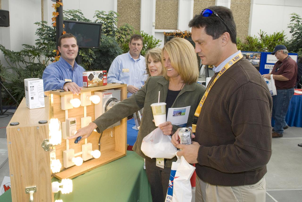 Stennis Space Center employees Maria Etheridge (l to r), Linda Sauland Maurice Prevost visit a Coast Electric Power Association display featuring energy-efficient light bulbs during 2009 Energy Awareness Day activities on Oct. 20. The exhibit was one of several energy-efficiency and energy-awareness displays on-site for employees to visit. Vendors included Mississippi Power Company, Coast Electric Power Association, Mississippi Development Authority - Energy Division,Jacobs FOSC Environmental, Southern Energy Technologies, and Siemens Building Technologies.
