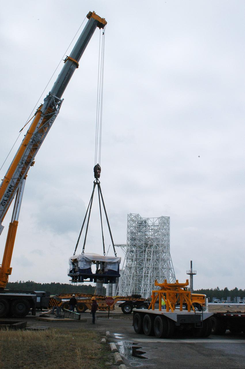 A state-of-the-art thrust measurement system for the A-3 Test Stand under construction at NASA's John C. Stennis Space Center was delivered March 17. Once completed, the A-3 stand (seen in background) will allow simulated high-altitude testing on the next generation of rocket engines for America's space program. Work on the stand began in 2007, with activation scheduled for 2012. The stand is the first major test structure to be built at Stennis since the 1960s. The recently delivered TMS was fabricated by Thrust Measurement Systems in Illinois. It is an advanced calibration system capable of measuring vertical and horizontal thrust loads with an accuracy within 0.15 percent at 225,000 pounds.
