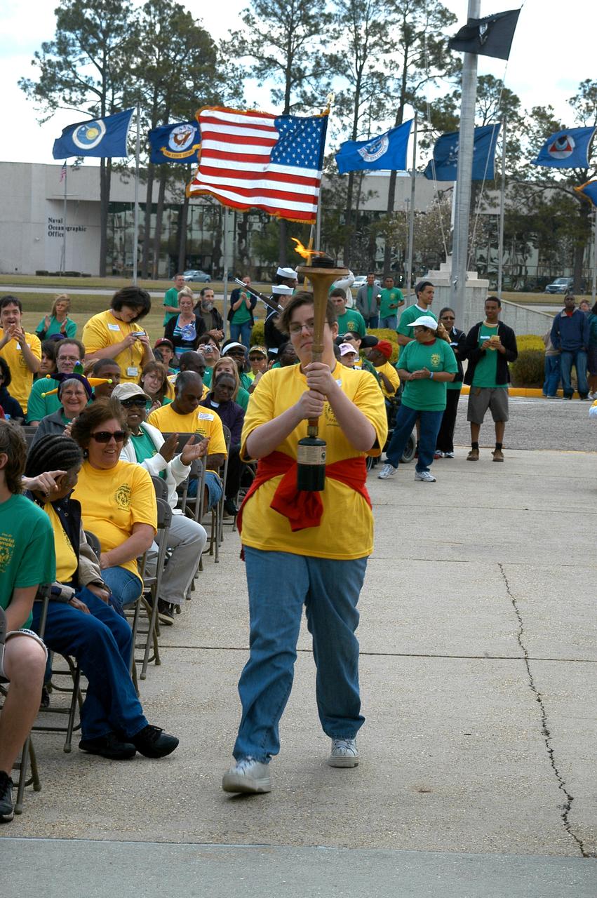 Sarah Johnson, 28, of Gulfport, carries in the Olympic torch to signal the start of the 2010 Area III Special Olympic games at NASA's John C. Stennis Space Center on March 27. Stennis volunteers hosted special needs athletes from across the area for the event. Stennis is an annual host of the games.