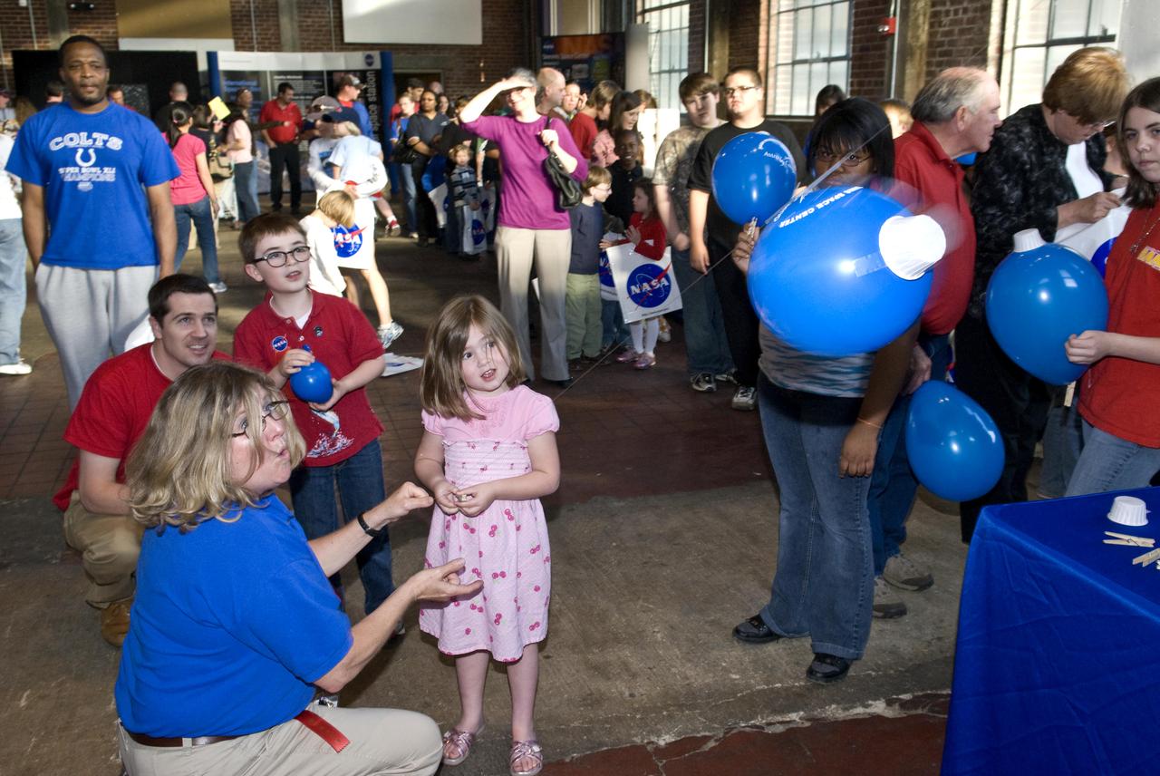 A young visitor to the Powerhouse Community Arts and Cultural Center in Oxford, Miss., enjoys a balloon rocket transportation activity during a NASA Night in the Neighborhood on March 29. NASA's John C. Stennis Space Center near Bay St. Louis visited the center with a variety of space-related displays and educational activities. Events targeted for children included moon phasers and build-your-own rocket transportation exercises, as well as an astronaut ice cream tasting station. Visitors also were able to take photos in the astronaut suit display. Displays focused on the 40th anniversaries of the Apollo 11 and Apollo 13 lunar missions, the International Space Station, and various aspects of Stennis work. The event was sponsored by the NASA Office of External Affairs and Education at Stennis.