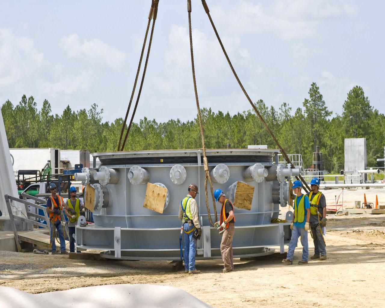 Work on the A-3 Test Stand at Stennis Space Center took a step forward in July with delivery of the first-stage steam ejector July 13. Stennis employees are shown preparing the ejector to be lifted into place on the test stand. When activated in 2012, the A-3 Test Stand will allow operators to test rocket engines at simulated altitudes of 100,000 feet, a critical feature for next-generation engines that will take humans beyond low-Earth orbit once more.