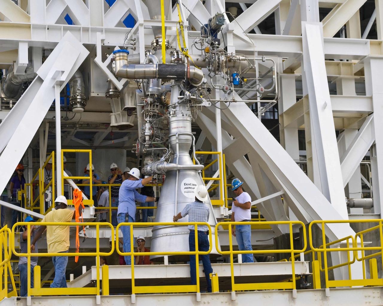 Stennis employees at the E-1 Test Stand position an Aerojet AJ26 rocket engine in preparation for a series of early tests. Stennis has partnered with Orbital Sciences Corporation to test the rocket engine for the company's commercial cargo flights to the International Space Station.