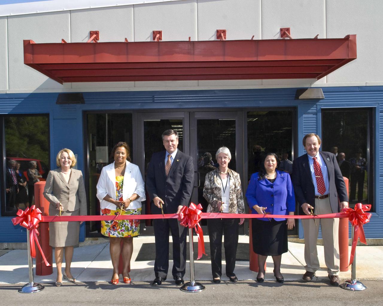 NASA's John C. Stennis Space Center cut the ribbon Aug. 24 on a new, storm-resistant Records Retention Facility that consolidates and protects records storage at the nation's premier rocket engine test facility. This facility will also house history office operations. Participants in the ribbon-cutting included: (l to r) Gay Irby, Center Operations deputy director at Stennis; Linda Cureton, NASA chief information officer; Patrick Scheuermann, Stennis director; Jane Odom, NASA chief archivist; Dinna Cottrell, Stennis chief information officer; and James Cluff, Stennis records manager.
