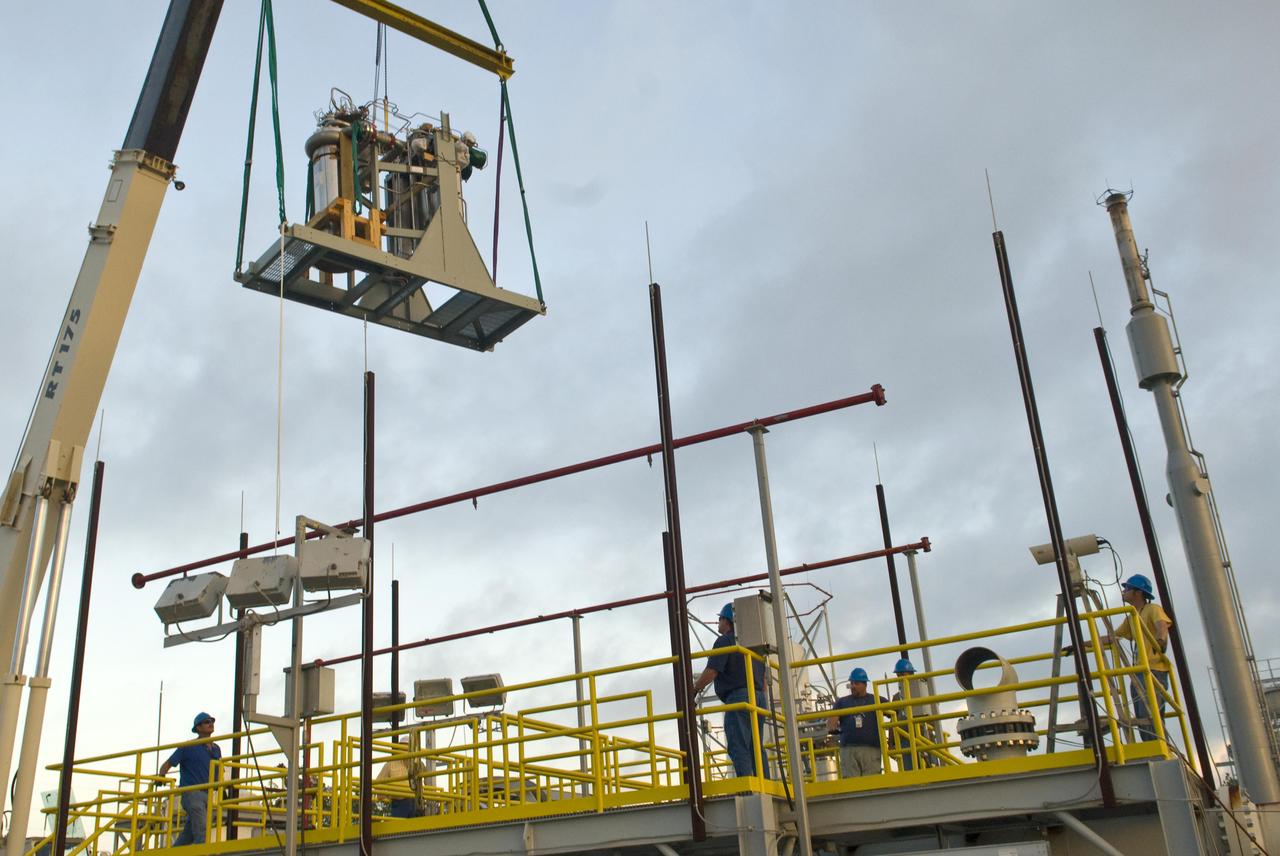 The first of nine chemical steam generator (CSG) units that will be used on the A-3 Test Stand is hoisted into place at the E-2 Test Stand at John C. Stennis Space Center on Oct. 24, 2010. The unit was installed at the E-2 stand for verification and validation testing before it is moved to the A-3 stand. Steam generated by the nine CSG units that will be installed on the A-3 stand will create a vacuum that allows Stennis operators to test next-generation rocket engines at simulated altitudes up to 100,000 feet.