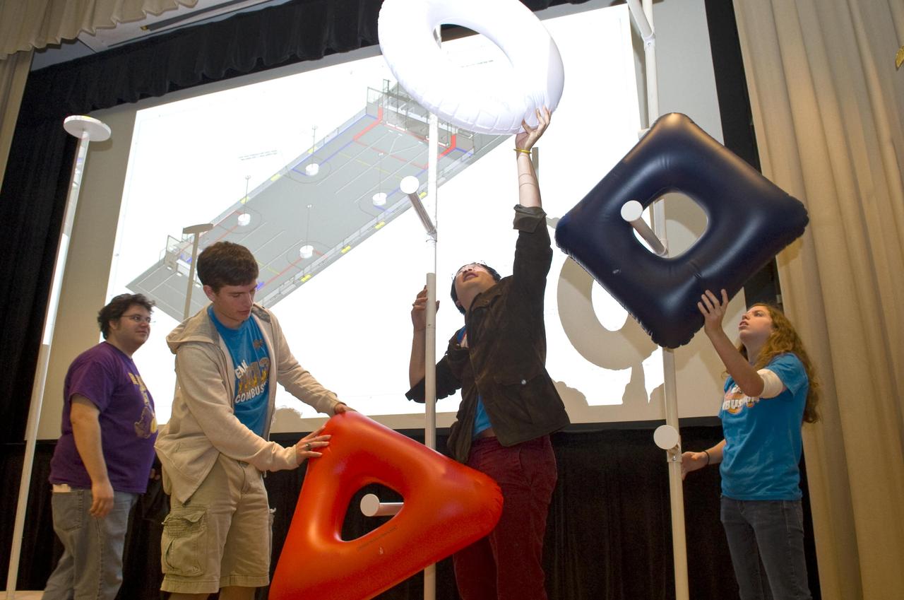 Chris Collins (l to r), Andy Zhou and Rachel Holladay from Northshore High School in Slidell place FIRST logo pieces during a Jan. 7, 2011 kickoff event for the 2011 FIRST (For Inspiration and Recognition of Science and Technology) Robotics Competition season. Thirty teams from four states attended the kickoff event at Stennis Space Center.