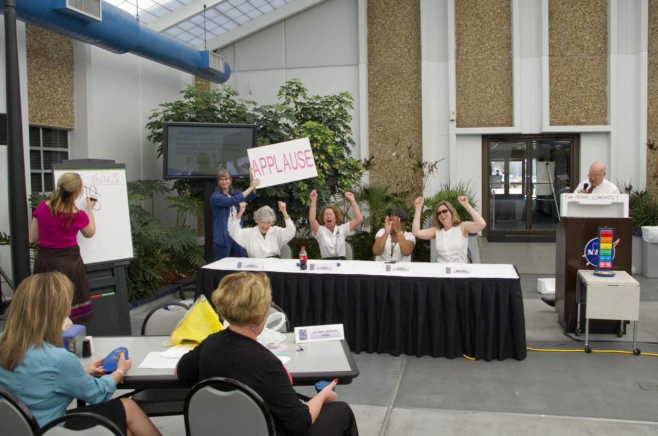 John C. Stennis Space Center employees (l to r) Janet Kovac (NASA Shared Services Center), Lael Butler (Environmental Protection Agency Gulf of Mexico Program), Mary Carter (NSSC) and Maura Lohrenz (Naval Research Laboratory) celebrate a correct answer during the Women's History Month Quiz Bowl held onsite March 24. The contest between the women and a panel of four men tested each side's knowledge of women's history facts and events. This year's Women's History Month theme was 'Our History is Our Strength.' Befitting that sentiment, the panel of women won the contest.