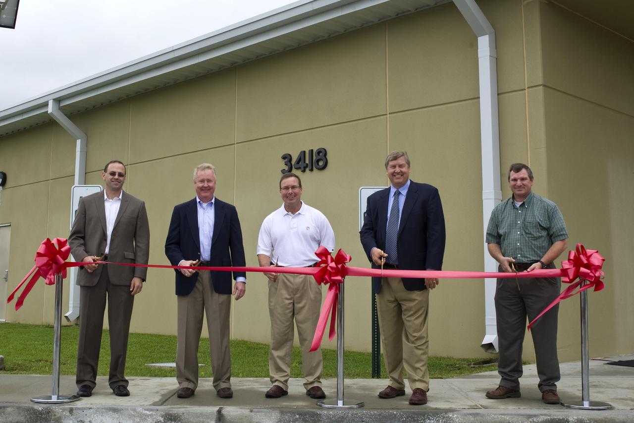 NASA cut the ribbon on a new cryogenics control center at John C. Stennis Space Center on March 30. The new facility is part of a project to strengthen Stennis facilities to withstand the impacts of future storms like hurricane Katrina in 2005. Participants in the ribbon-cutting included (l to r): Jason Zuckerman, director of project management for The McDonnel Group; Keith Brock, director of the NASA Project Directorate at Stennis; Stennis Deputy Director Rick Gilbrech; Steve Jackson of Jacobs Technology; and Troy Frisbie, Cryo Control Center Construction project manager for NASA Center Operations at Stennis.