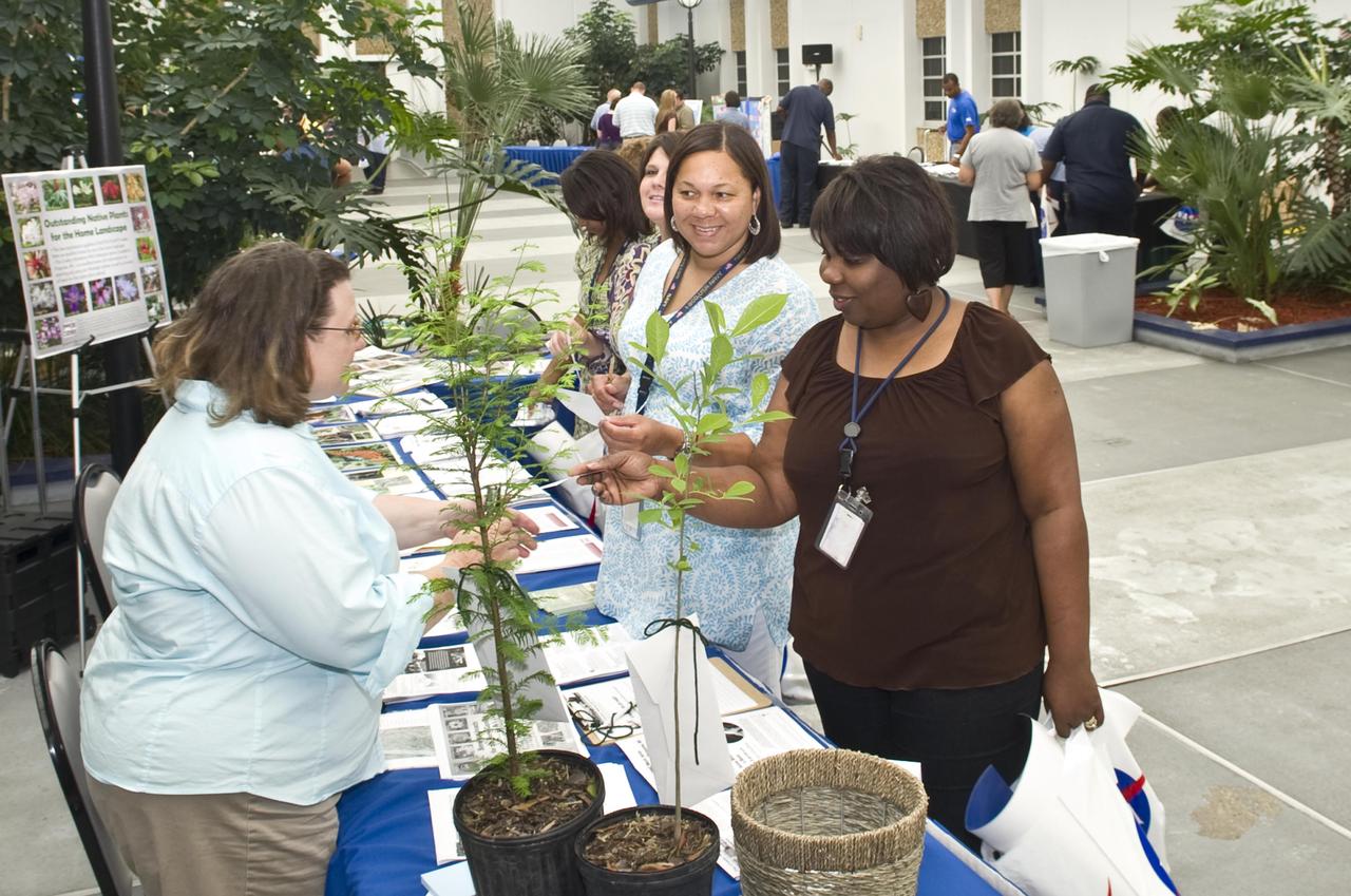 Pat Drackett of the Crosby Arboretum in Picayune (l) speaks with Helen Robinson and Arlene Brown, both employees of the Naval Oceanographic Office at Stennis Space Center, during Earth Day 2011 activities April 21. During the day, Stennis employees were able to visit various exhibits featuring environmentally friendly and energy-conscious items and information. The activities were coordinated by the Stennis Environmental Office.