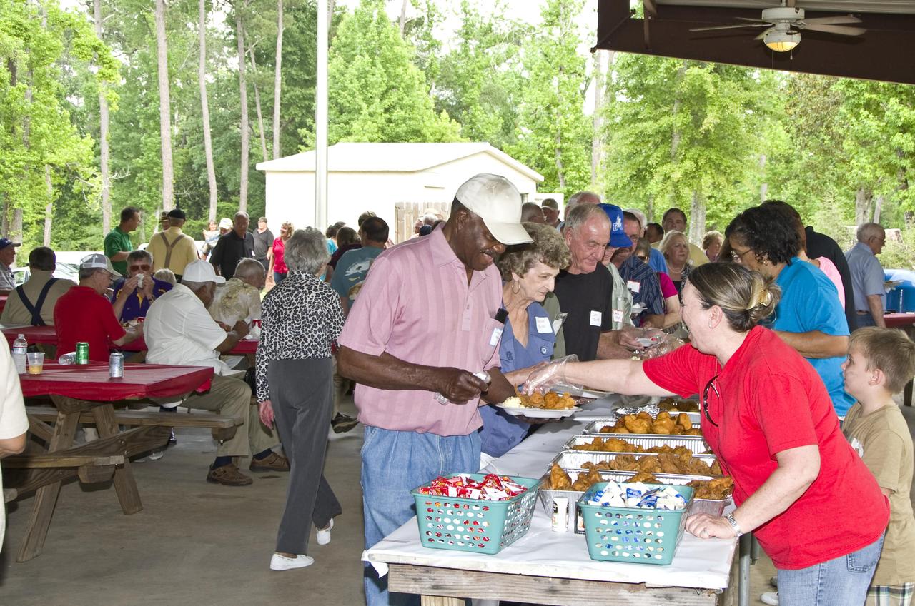 Former Stennis Space Center employees enjoy a return to the test facility for Old Timers' Day on May 20. About 175 former employees attended the annual event. 'It's wonderful to see people again you used to see every day,' retired employee Judy Mitchell said.
